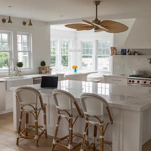  large white kitchen with ceiling fan above island  